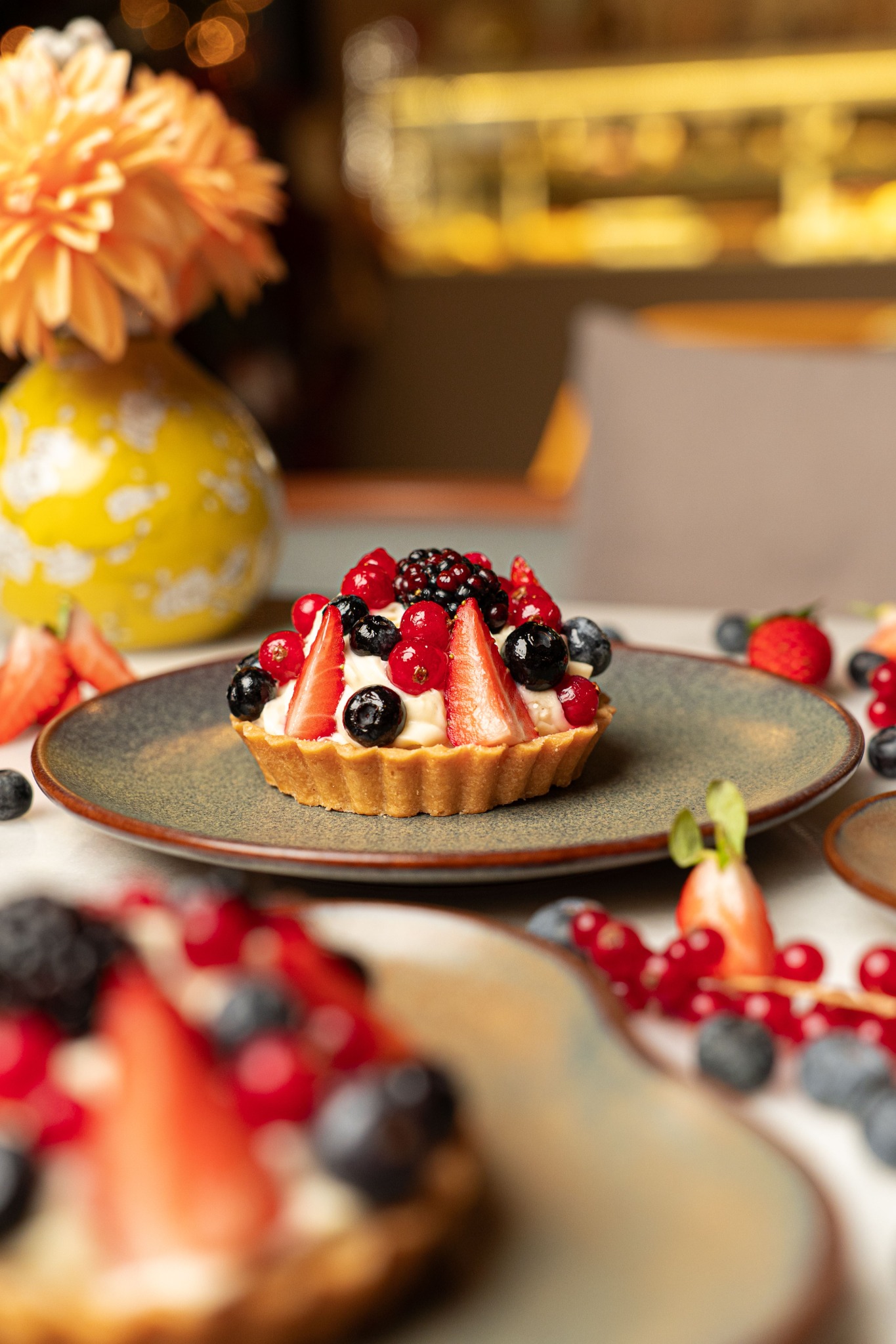 Berry tart in a warm pâtisserie setting